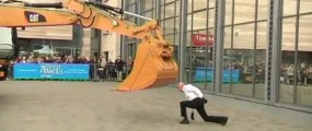 Philippe Priasso from dance troupe "Beau Geste" dances with a mechanical excavator